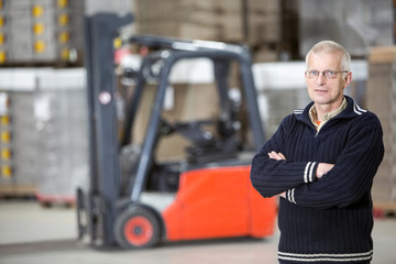 Confident Supervisor Standing At Warehouse
