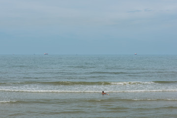 little boy playing with water on summer beach 