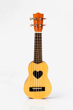 Close up of ukulele on white background
