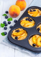 Homemade tartlets with peach and blueberries