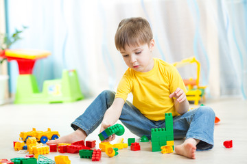 child boy plays on floor in nursery