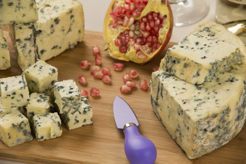 Different cheeses on a cutting board, delicious food