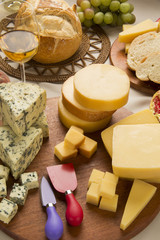 Different cheeses on a cutting board, delicious food