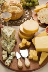 Different cheeses on a cutting board, delicious food
