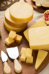Different cheeses on a cutting board, delicious food