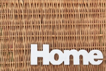 White Wood Sign Home On The Rustic Wicker Background