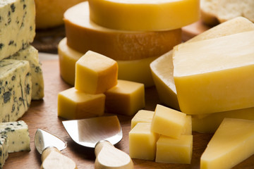 Different cheeses on a cutting board, delicious food