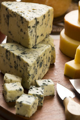 Different cheeses on a cutting board, delicious food