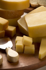 Different cheeses on a cutting board, delicious food