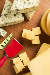 Different cheeses on a cutting board, delicious food
