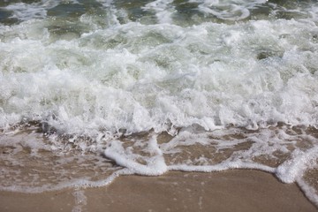 Close up of sea waves splashing on shore