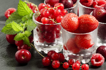 Assorted summer berries: raspberries, red currant, cherry, straw
