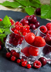 Assorted summer berries: raspberries, red currant, cherry, straw