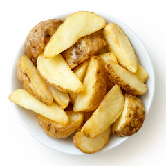 Bowl of fried potato wedges isolated on white. From above.