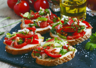 Italian bruschetta with tomato, onion and bell pepper, selective