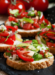 Italian bruschetta with tomato, onion and bell pepper, selective
