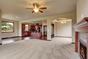 Lovely unfurnished living room with carpet.