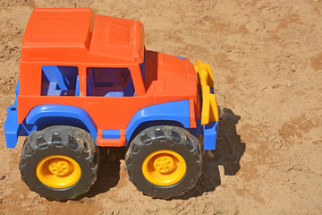 Toy car at the children sand-box. Closeup view