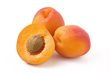 Two and half apricot with a stone on a white background