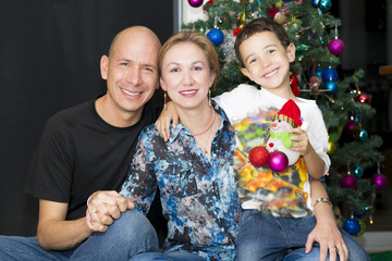 Fototapeta na wymiar Happy Family enjoying at home at Christmas