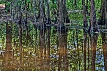 Fototapeta premium Breeze blows a curtain through a window near a simple table and chair