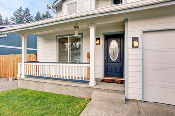 Traditional northwest home with navy blue door and white fencing