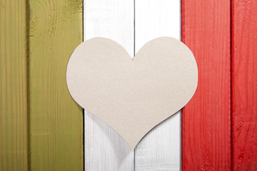 Stylized Italian flag with a cardboard heart in the middle..