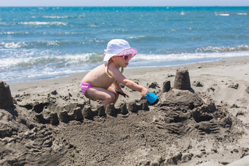 young lady is building a sand castle 