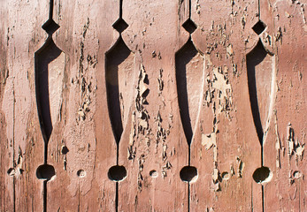 old painted boards with cracked paint and carved patterns