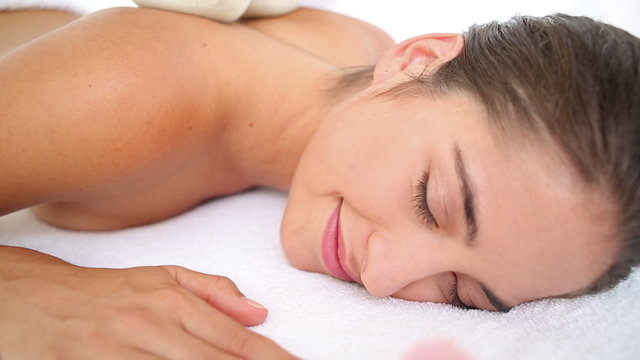 Woman enjoying a herbal compress massage