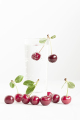 Cherry with bubbles in the glass of water
