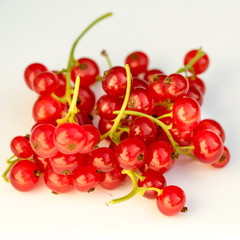 Ripe red currant on a white background