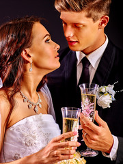 Wedding couple drinking champagne.