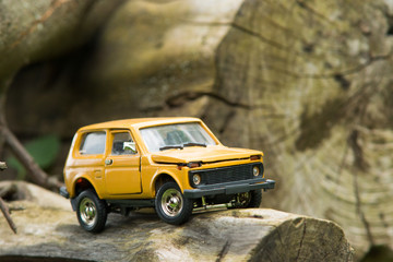 Obraz na płótnie Canvas Toy SUV on Logs