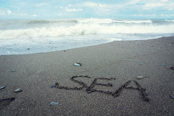 Fototapeta na wymiar Sea word written on the sand
