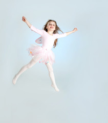 Cute girl in fairy costume jumping in the studio