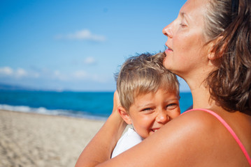 Fototapeta na wymiar Mother and her son at beach