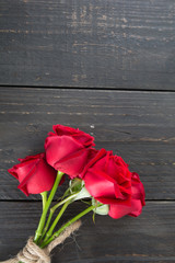 red rose bouquet on wood background