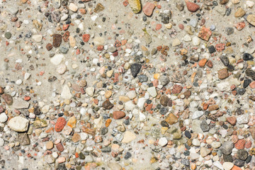 Sea stones on sand texture under the surface of the water.