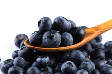 Fresh blueberries in wooden spoon