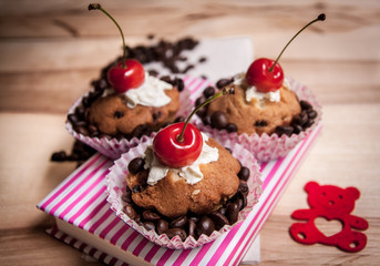 tasty muffin cakes with chocolate, spices and coffee seeds, close up