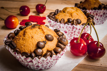 tasty muffin cakes with chocolate, spices and coffee seeds, close up