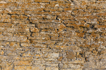 Old stone wall texture with moss