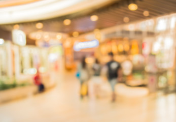 blurred image of shopping mall and people