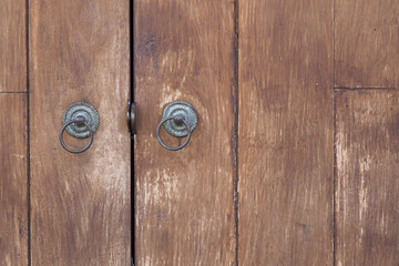the part of wooden door with metal handle
