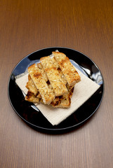 Garlic bread on black plate 