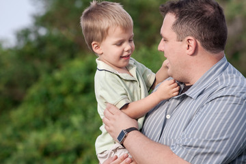father holding his 2 year old son