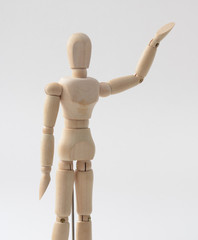 wood mannequin, demo human model posed raising hand as presenting message