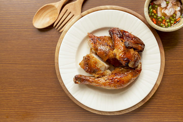 Golden brown grilled chicken with spicy sauce 