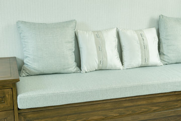Fototapeta na wymiar living room interior with white and gray pillows on wooden sofa